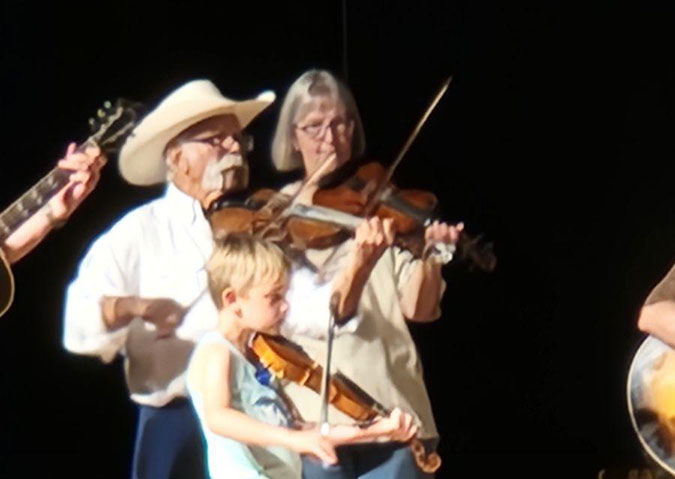 The youngest, Clark Huguenin, plays with grandfather Dan Everts and friend.