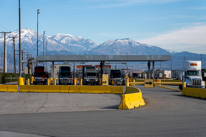 Trucks bring containers in through the front gate of San Bernardino Intermodal Facility.